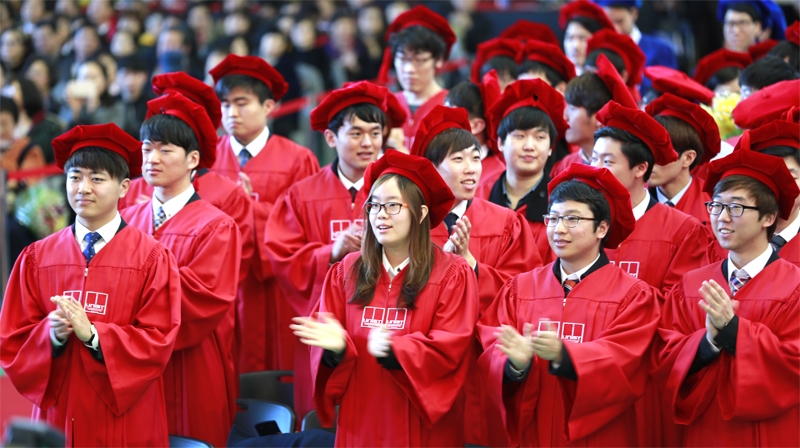Graduates at the 2015 Commencement Ceremony, wearing academic regalia.