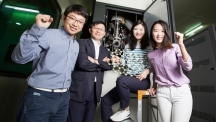 Prof. Zonghoon Lee's research team is posing for a group photo in front of the Advanced Transmission Electron Microscopy at UNIST. From left are Jongyeong Lee, Prof. Lee, GyeongHee Ryu, and HyoJu Park.