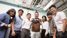 Prof. Jeong and his team are posing for a group photo, while holding 