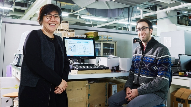 Prof. Mi Hee Lim of Natural Science (left) and her student, Jeffrey S. Derrick (right) are posing for a portrait at their lab, UNIST.