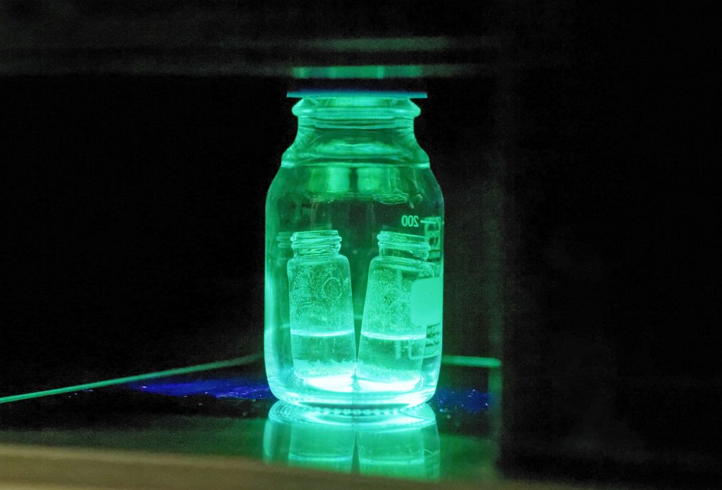 The water-stable perovskite sample under synthetic condition exhibits cyan green color in basic media during synthesis under UV light.