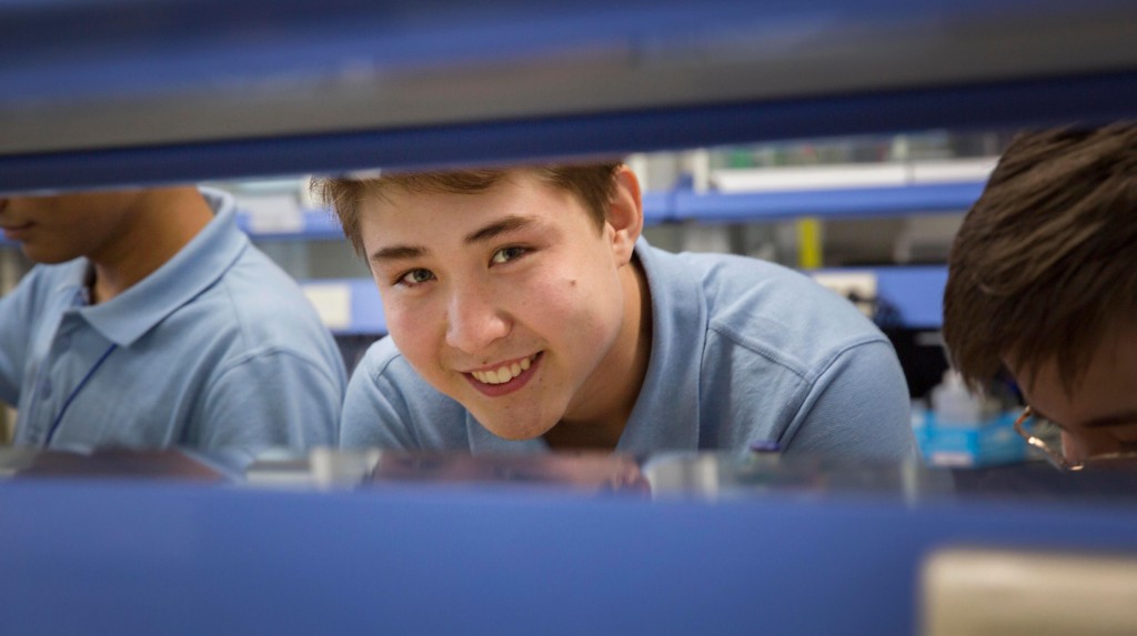 Almas Serikov from Kazakhstan is smiling during a lab project at the 2015 UNIST International Science Camp.