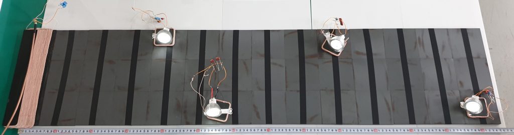 Figure 1. Four LED bulbs are lighted with the proposed WPT system. The maximum distance of a bulb from the Tx coil is 130 cm.
