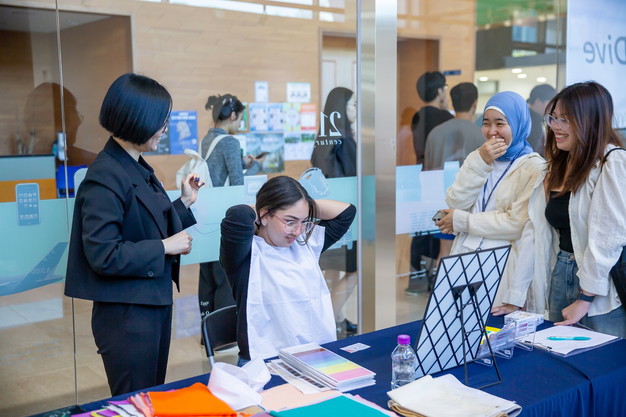 Participants at the Personal Color Consultation booth are seen discussing with the consultant and looking at color swatches. l Image Credit: IB Academic & Student Affairs Team