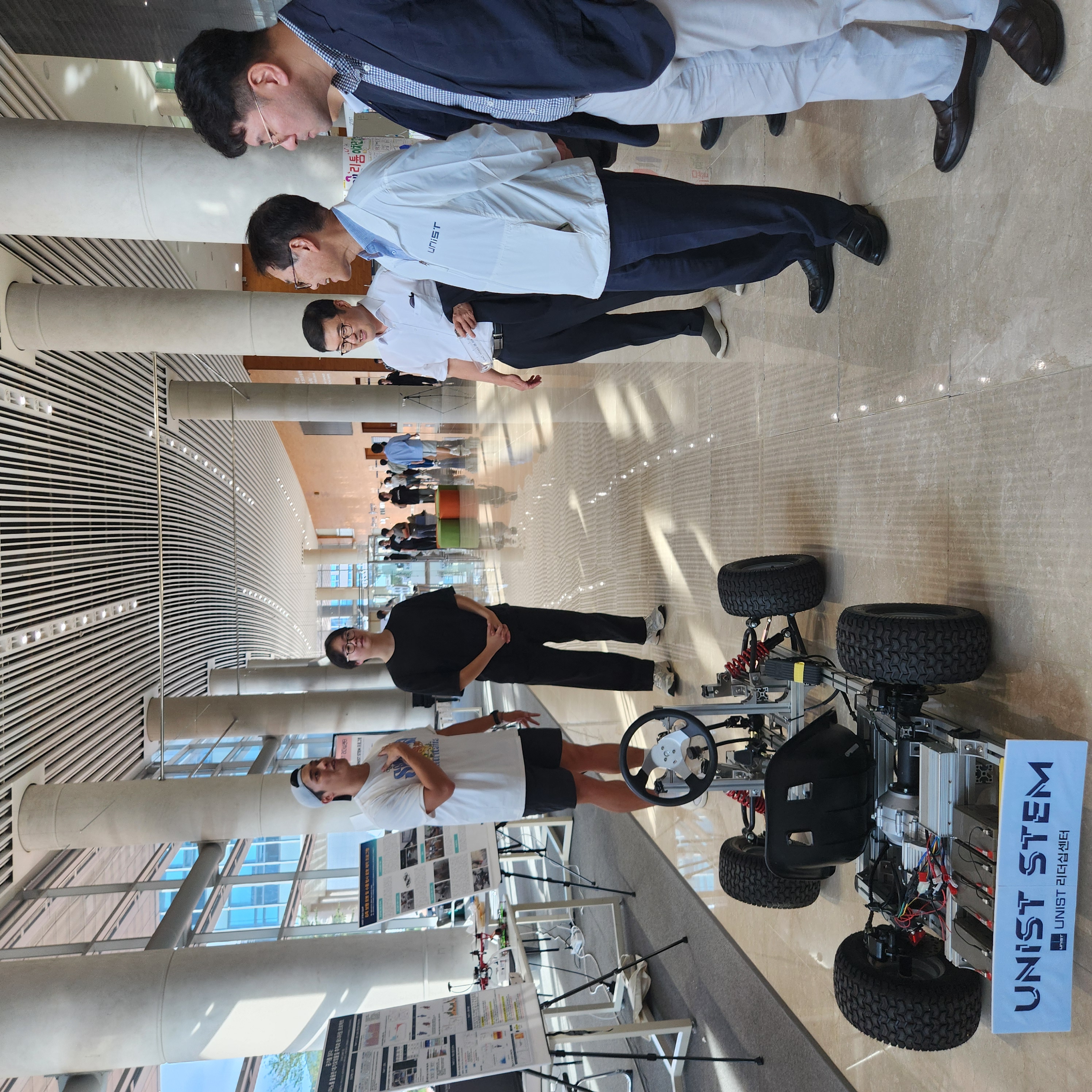 President Chong Rae Park is observing a demonstration of a small EV developed through students' creative ideas, showcasing innovative student projects. l Image Credit: Studio INGAM